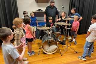 Students learning to play the drums