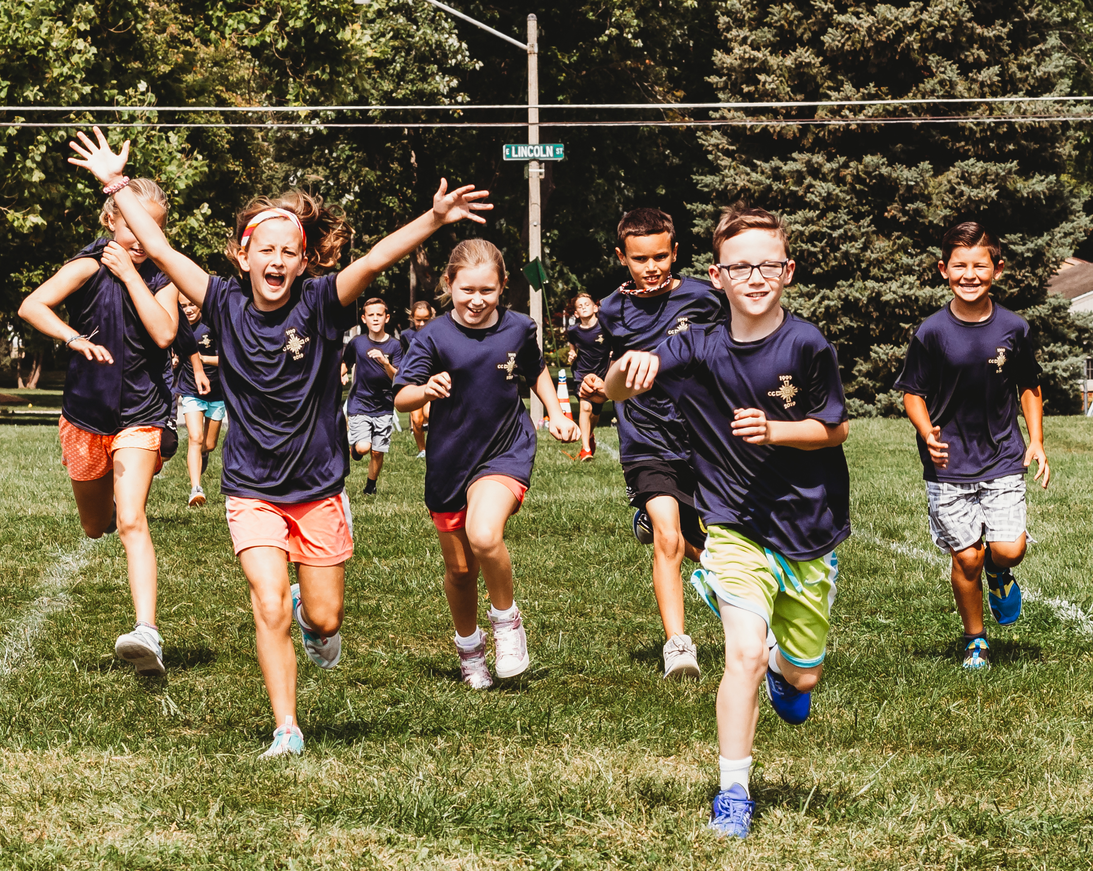 Corpus Christi students running in navy shirts