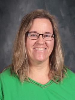 Woman wearing green shirt in school picture