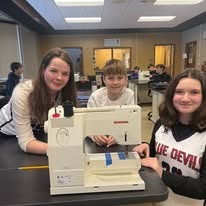 students working together on a sewing project