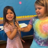 students giving high fives