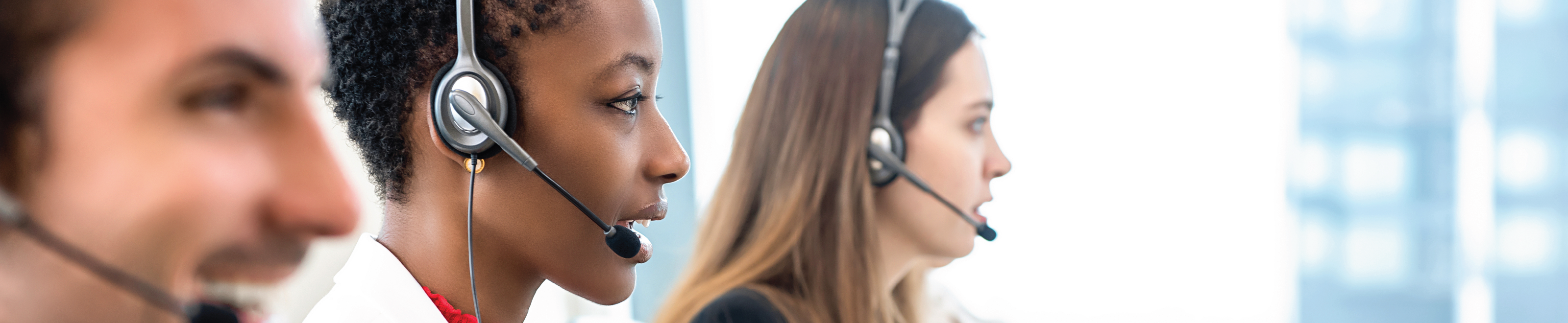 3 support staff with headset talking on the phone.