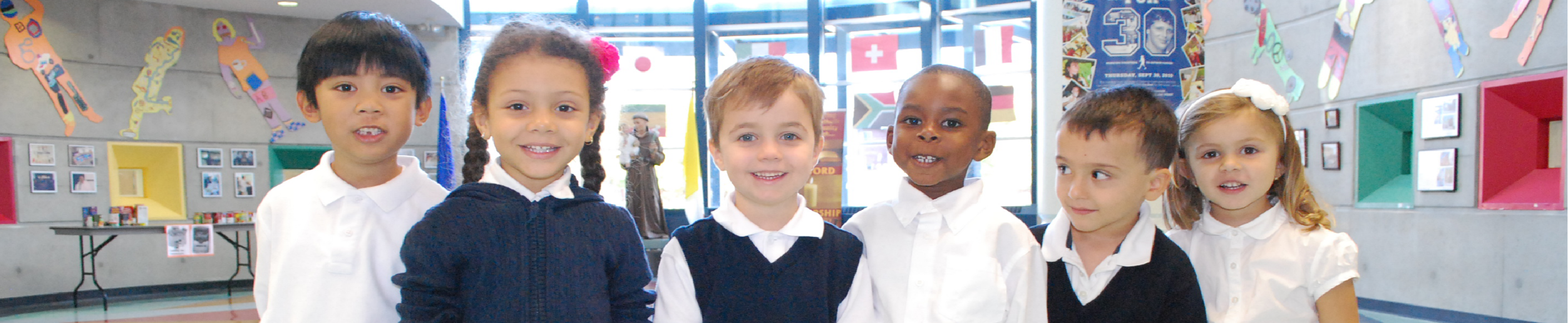 Six kindergarten students in various forms of TCDSB uniform.