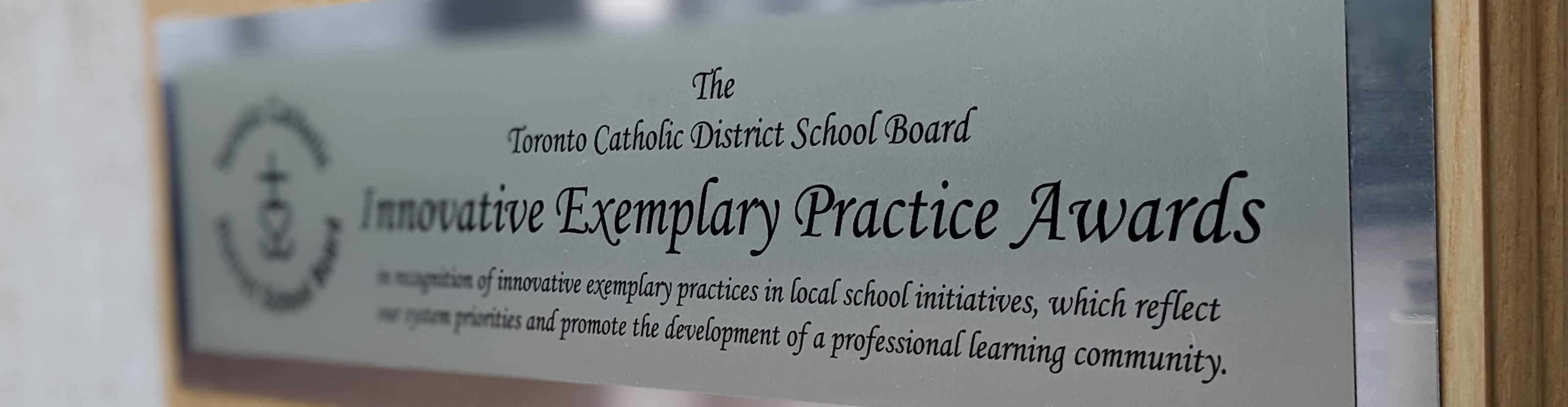 Photo of the Innovative Exemplary Practice Awards  plaque hung on a wall.