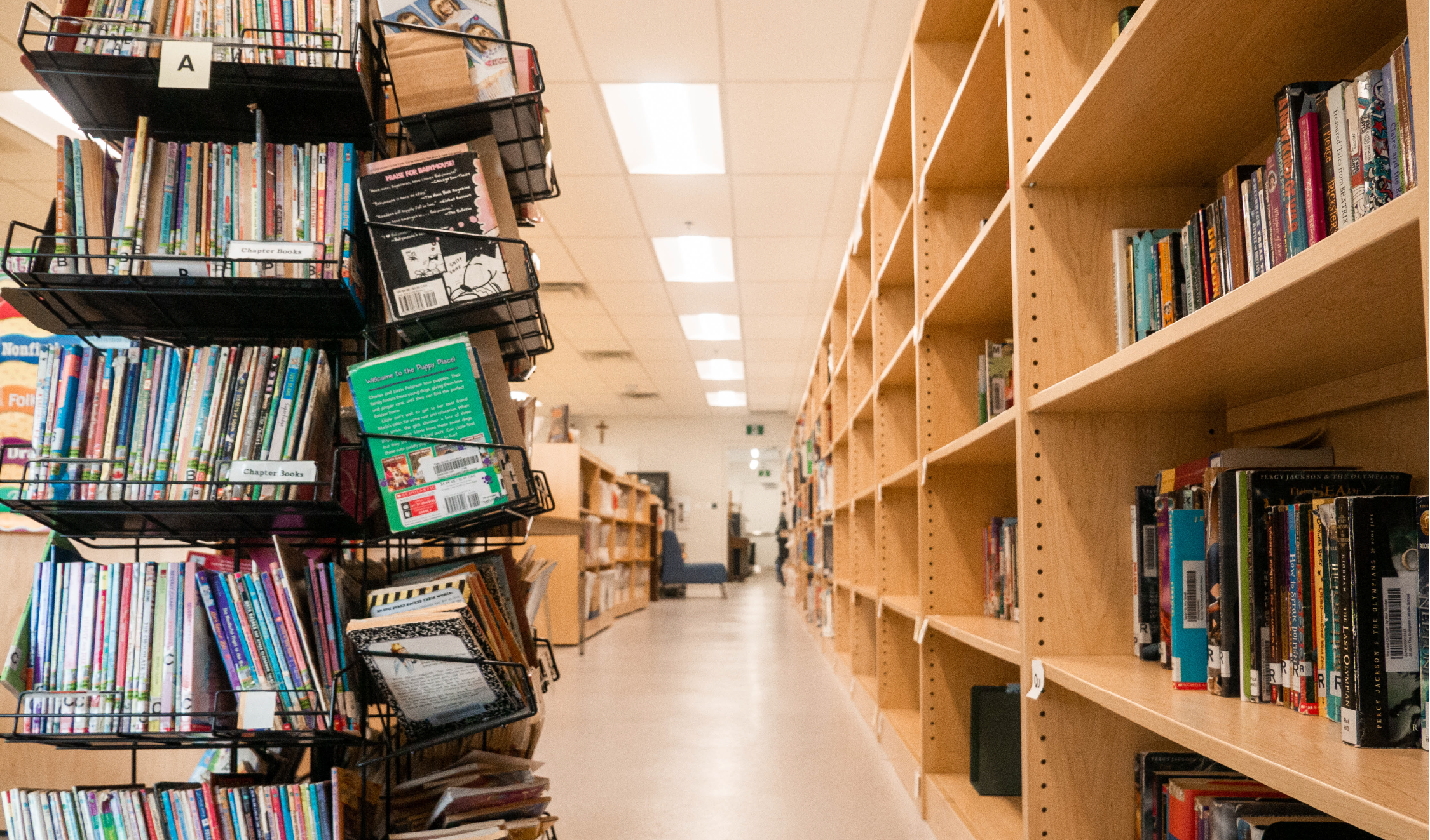 An image of a library with many rows of books. 