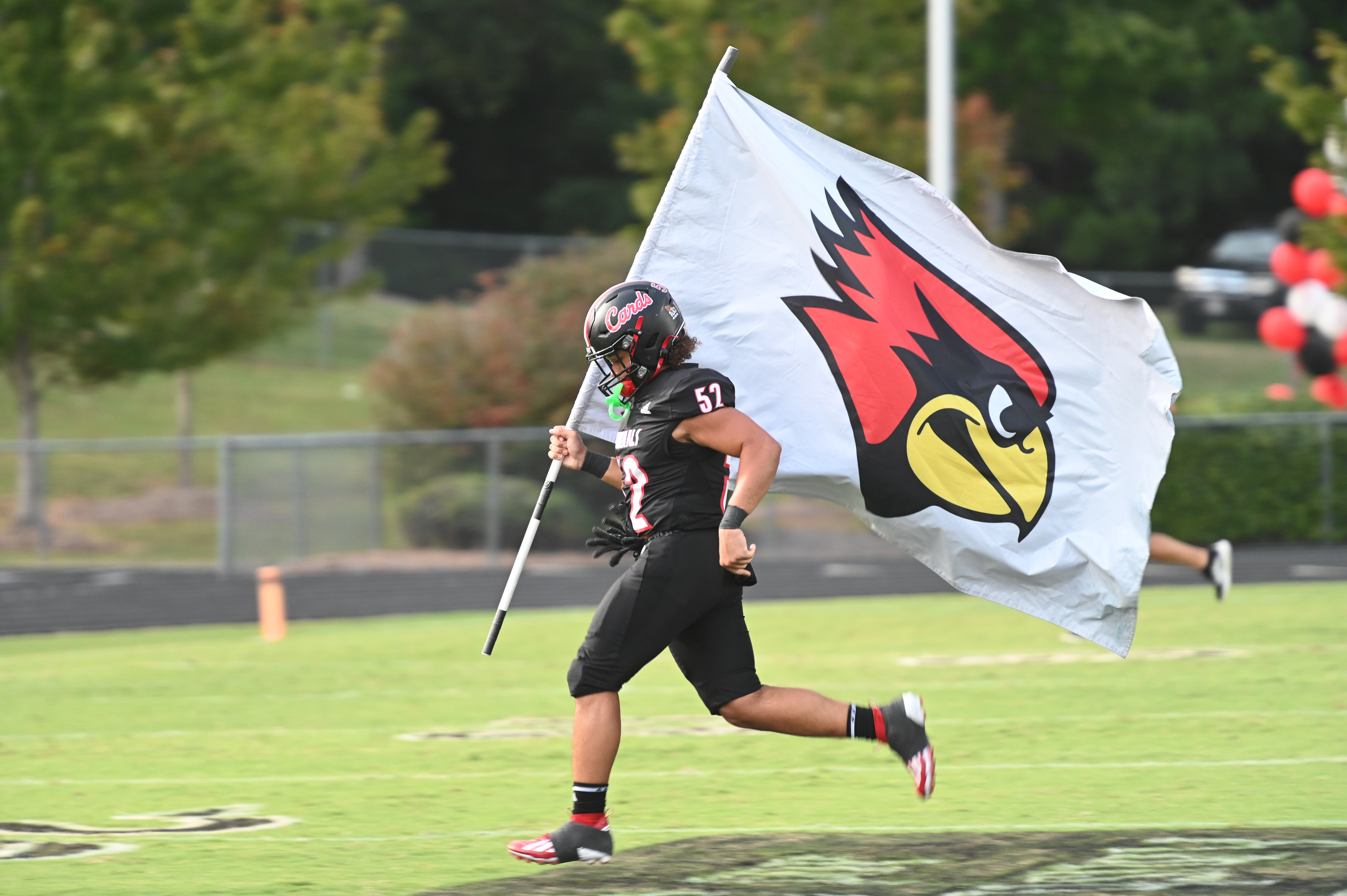 landrum high football player carrying flag