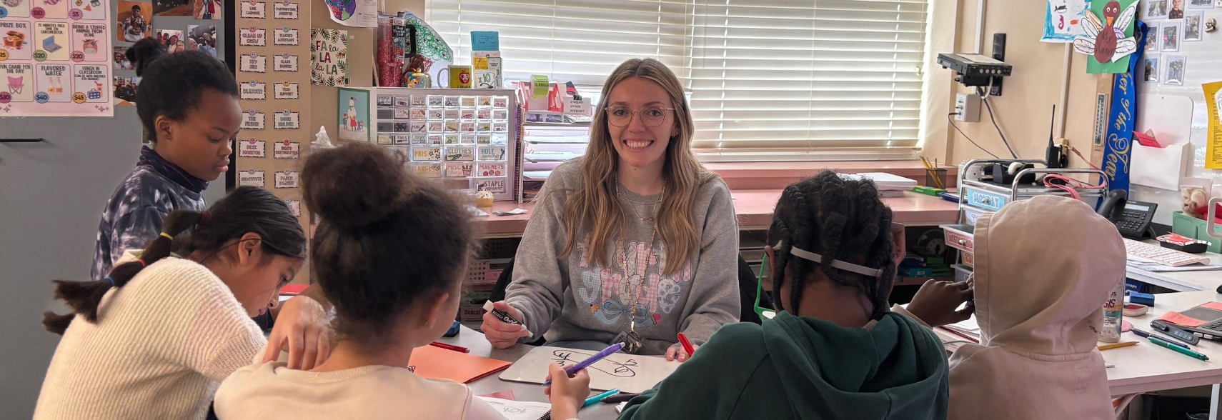 Teacher of the Year Kylie Warner sits in a circle with her students.