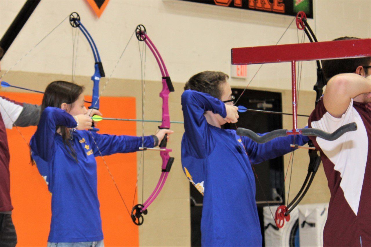 Students holding bow and arrows