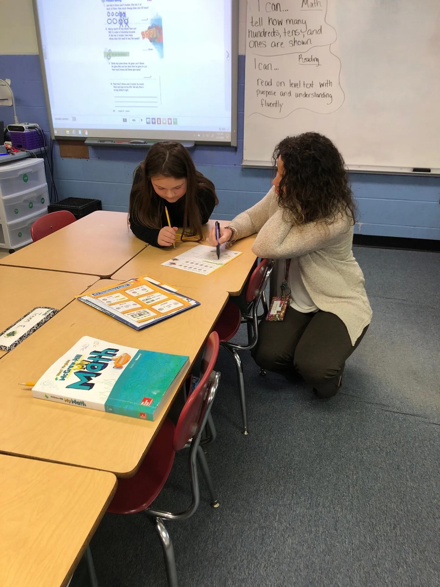 Student and teacher at a table