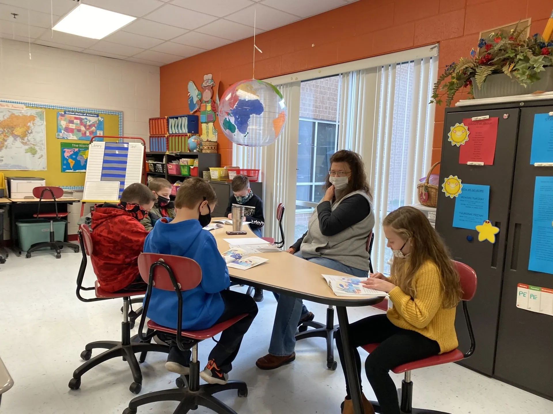 Students sitting at a table with a teacher