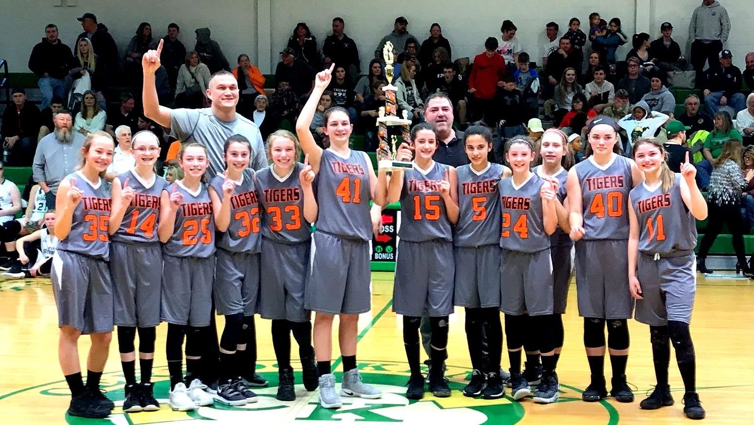 Basketball team holding a trophy