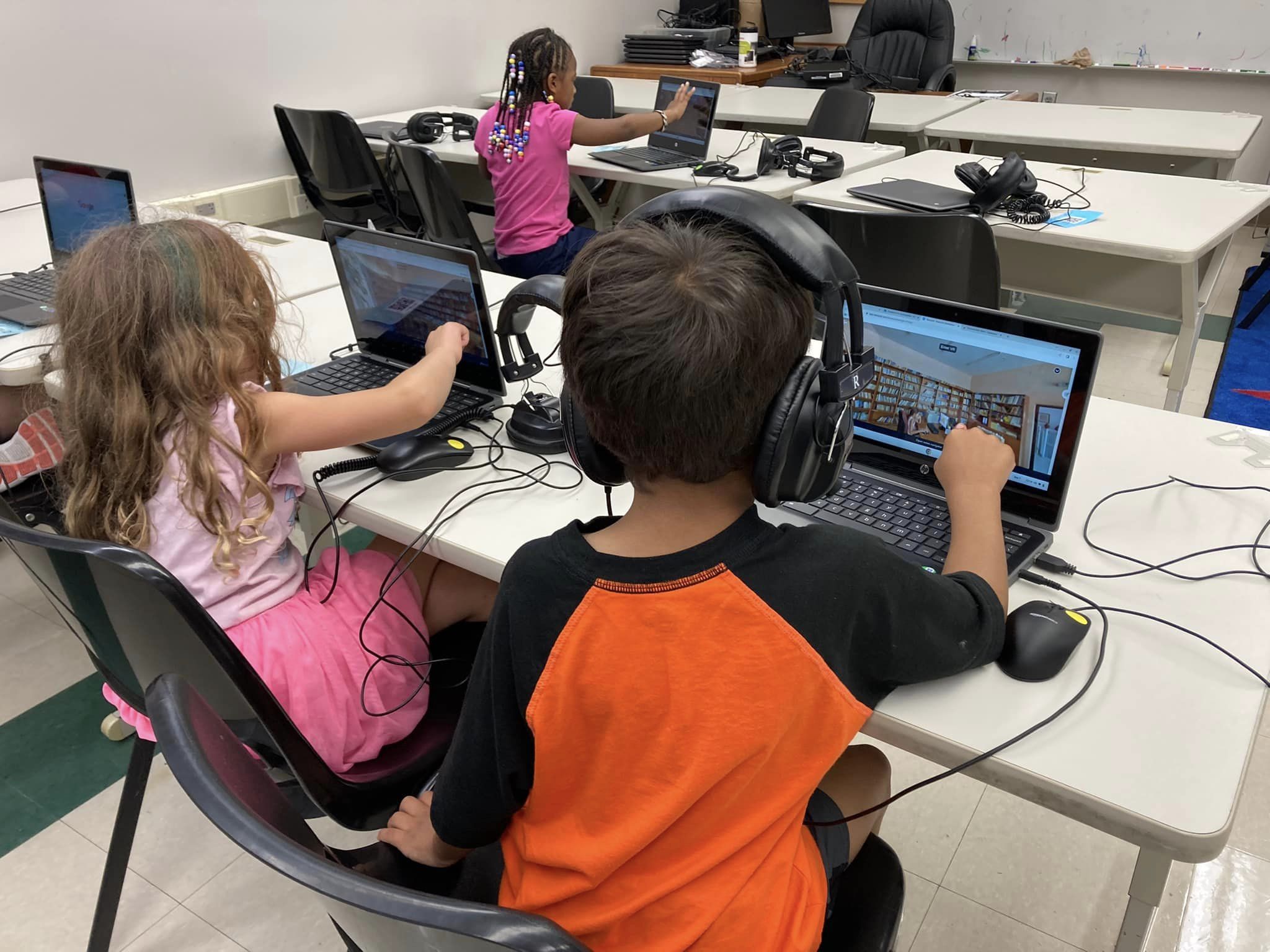 elementary students working on computers