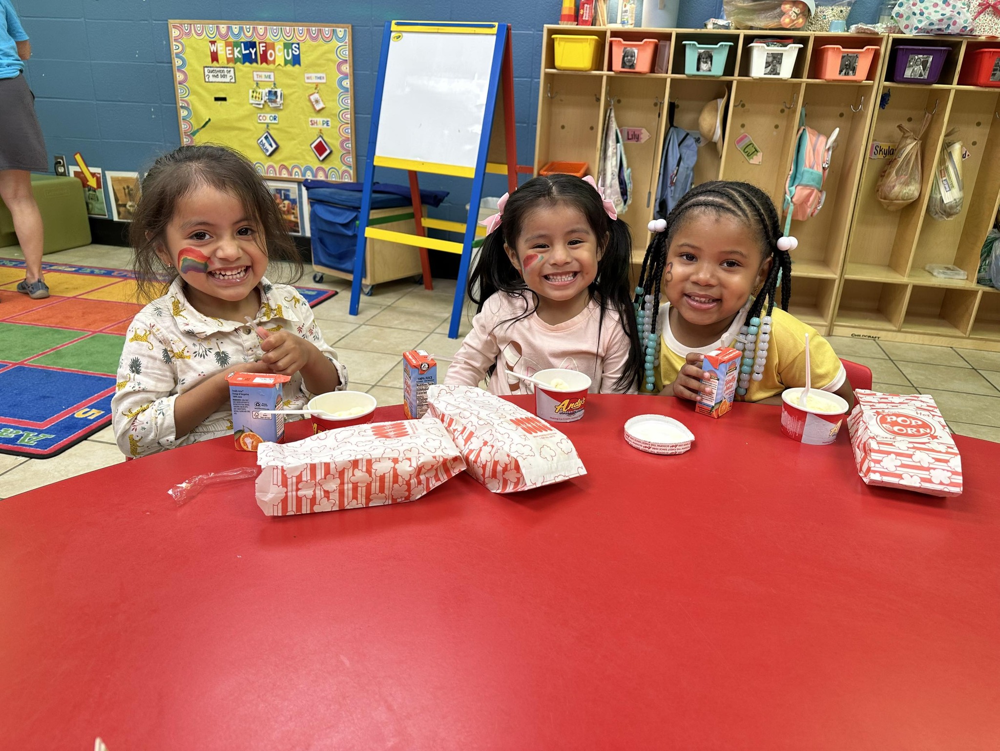 Students smile for a picture as they enjoy popcorn at the Early Childhood Center