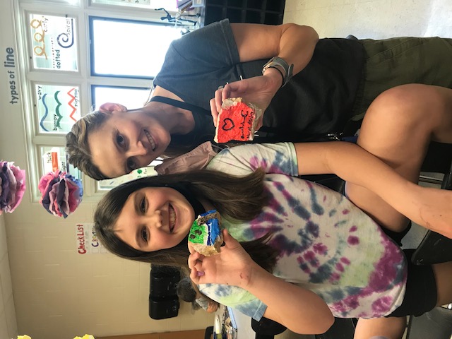 A nurse is pictured with a student as both smile for the camera