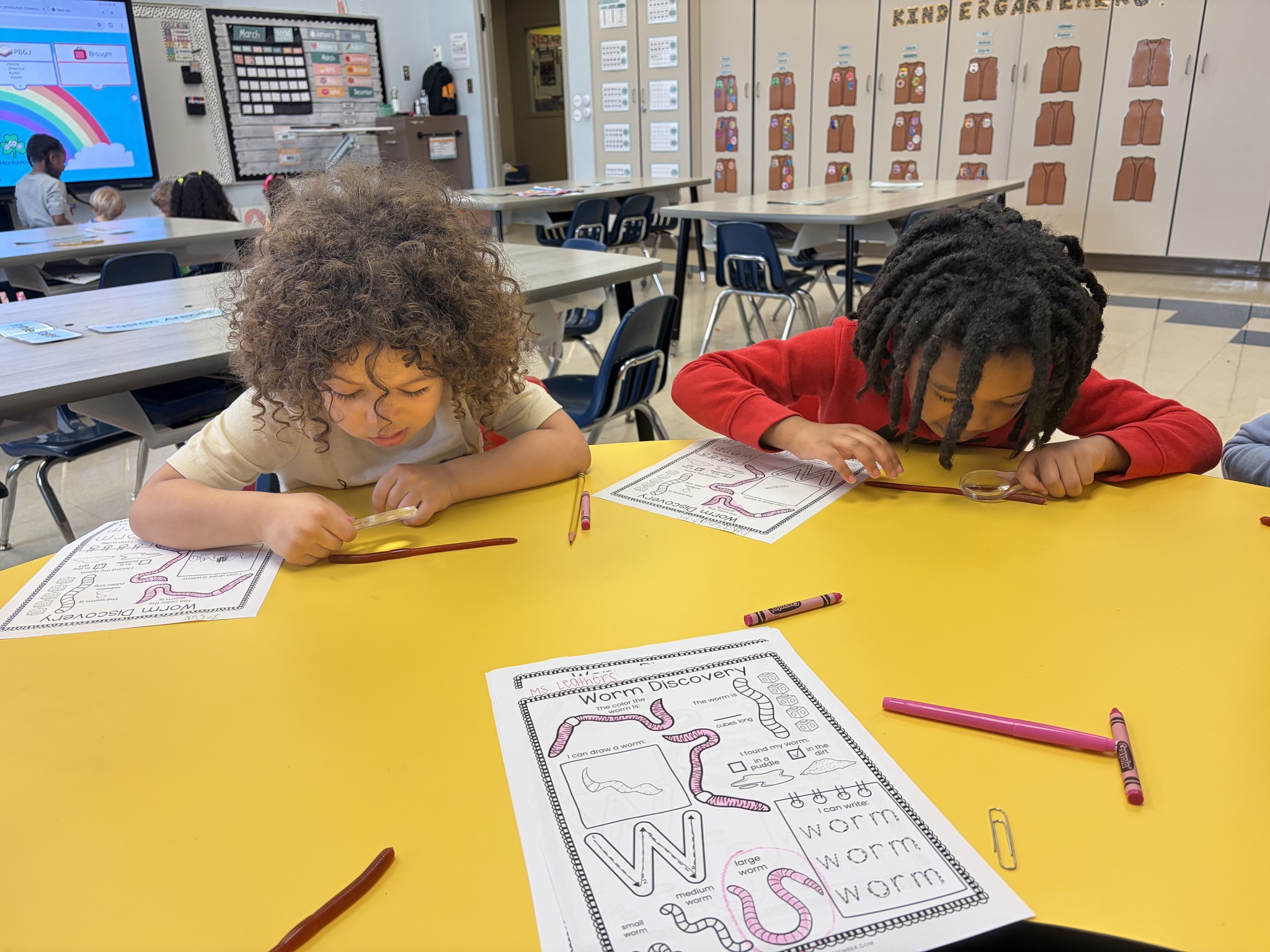 students at Blanchard use a magnifying glass