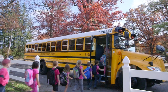 students getting into school bus