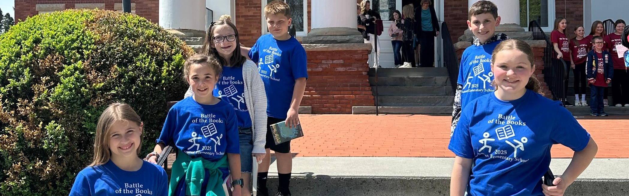 kids and adults posing for battle of the books