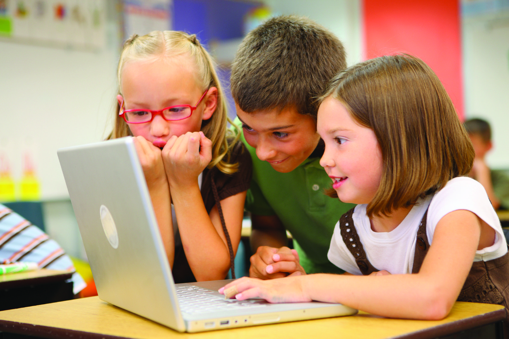 picture of three students at a computer