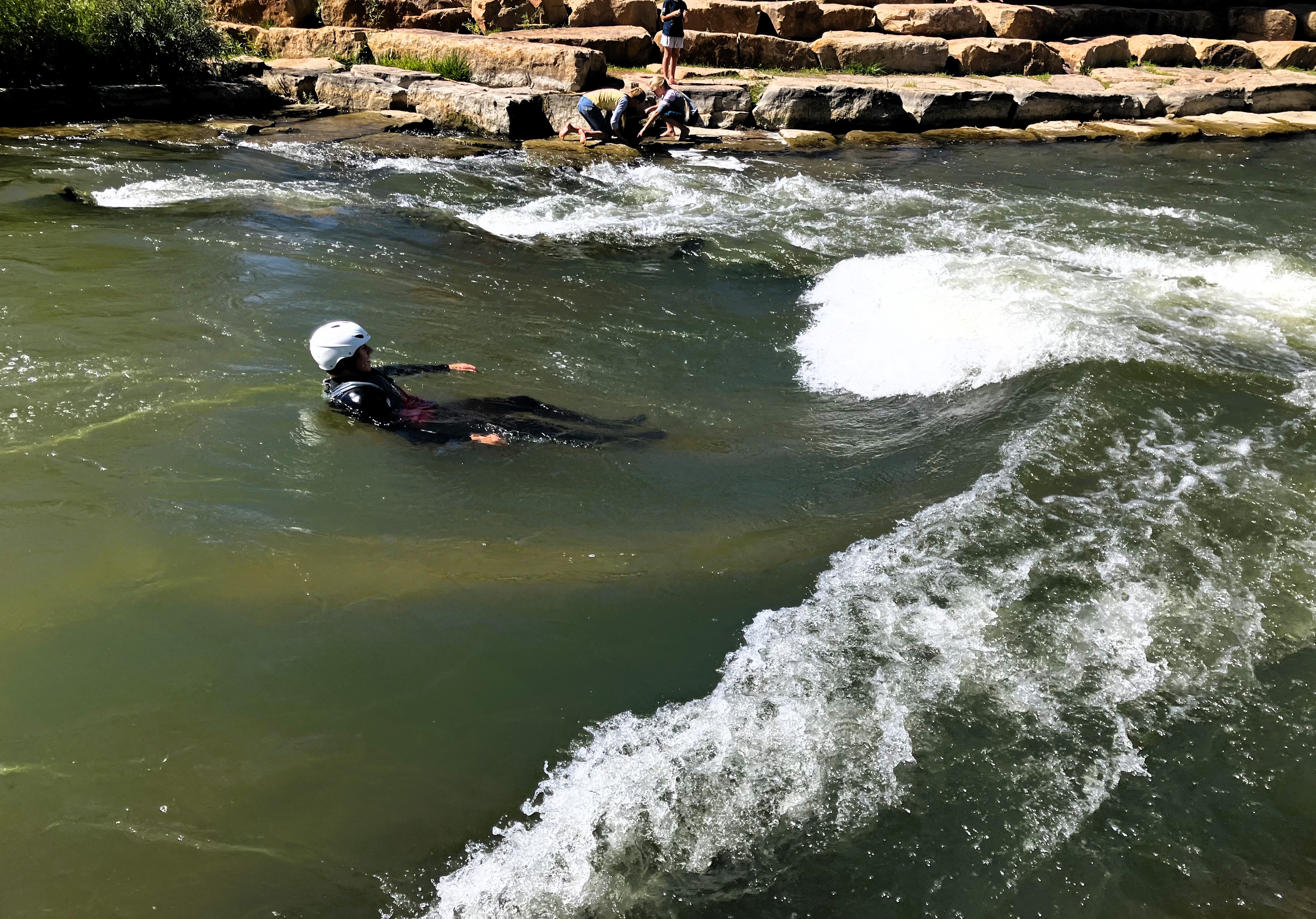 High School student river surfing at the Montrose Riverbottom Park