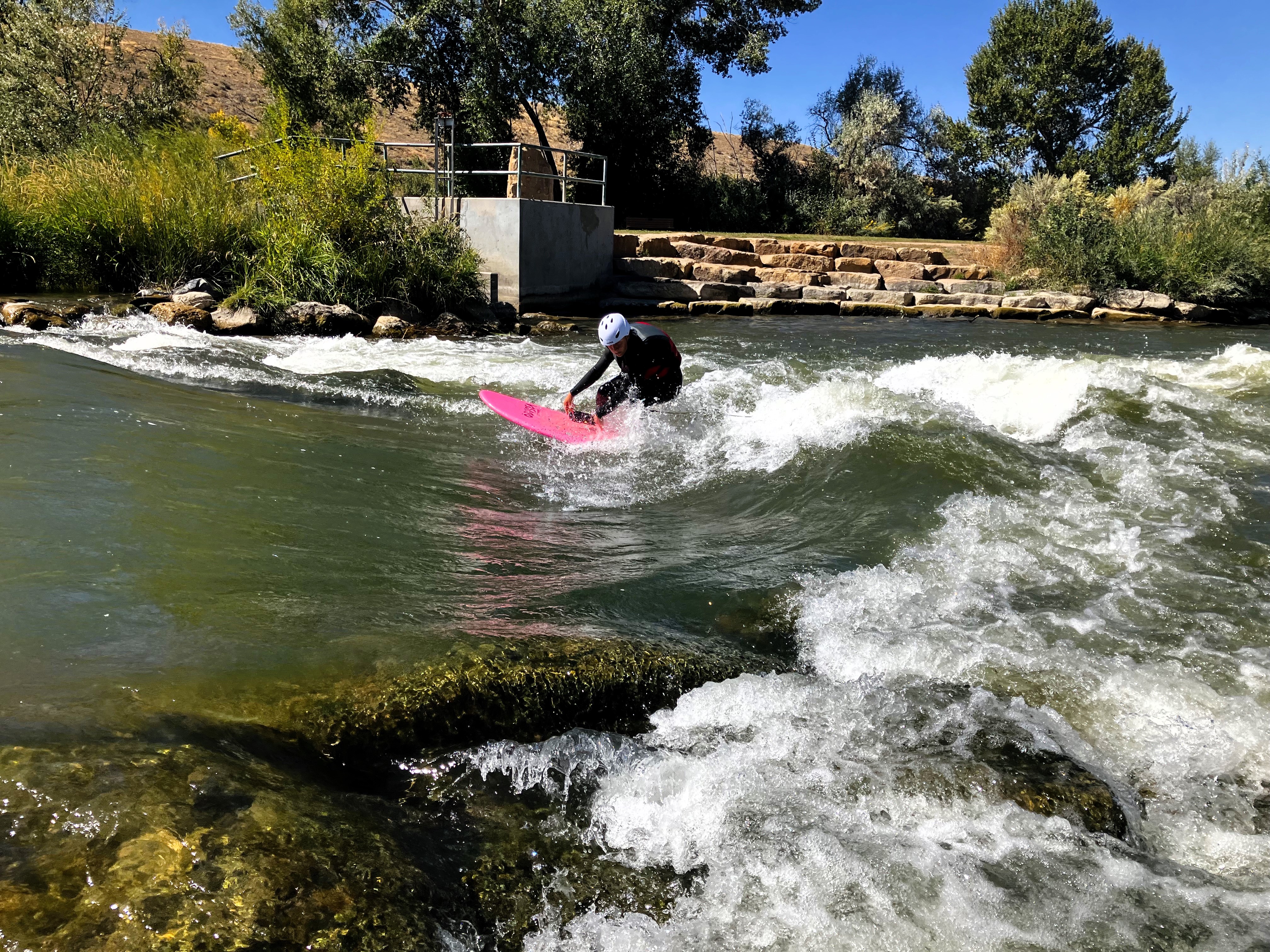 High School student river surfing at the Montrose Riverbottom Park