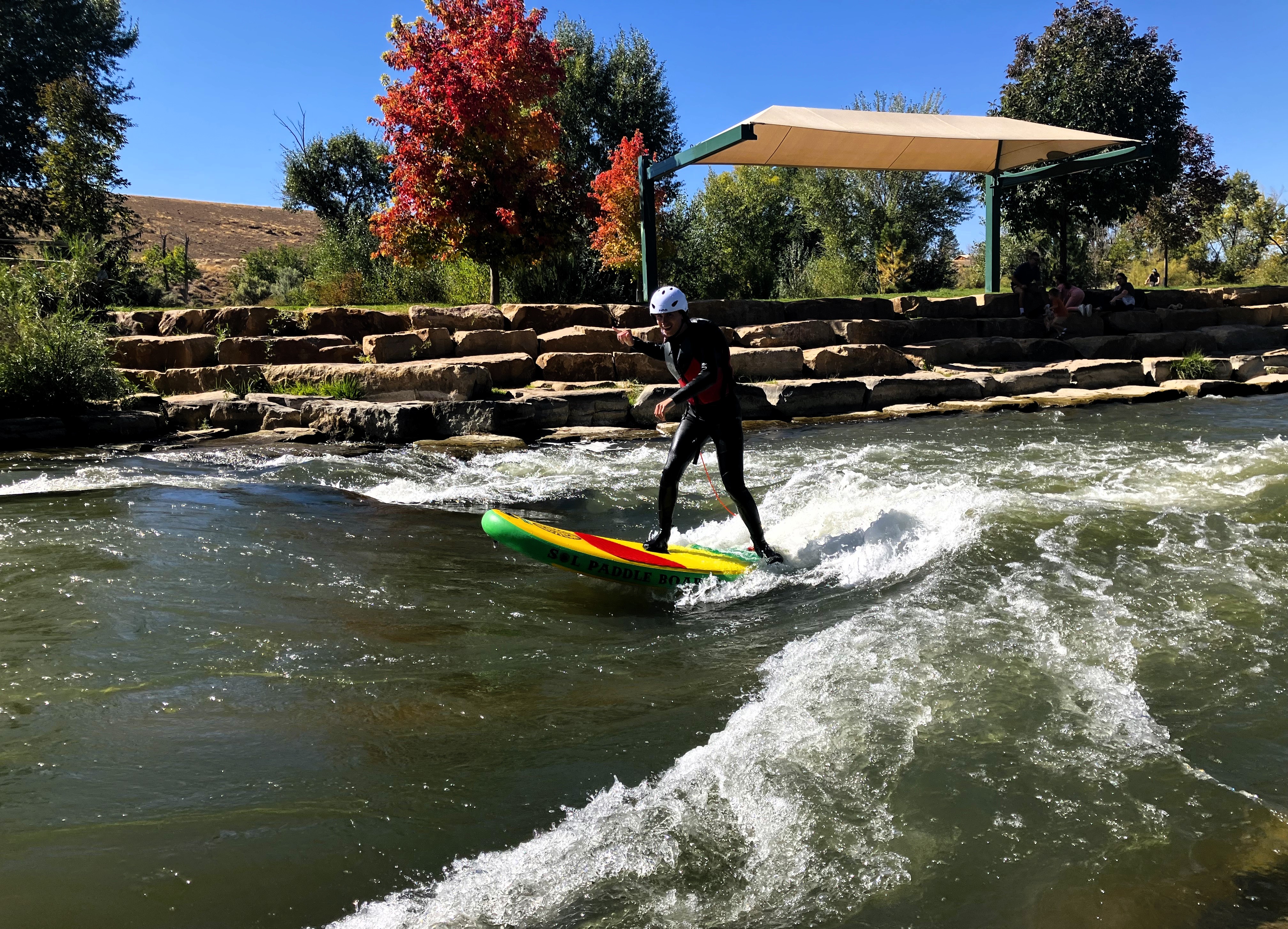 High School student river surfing at the Montrose Riverbottom Park