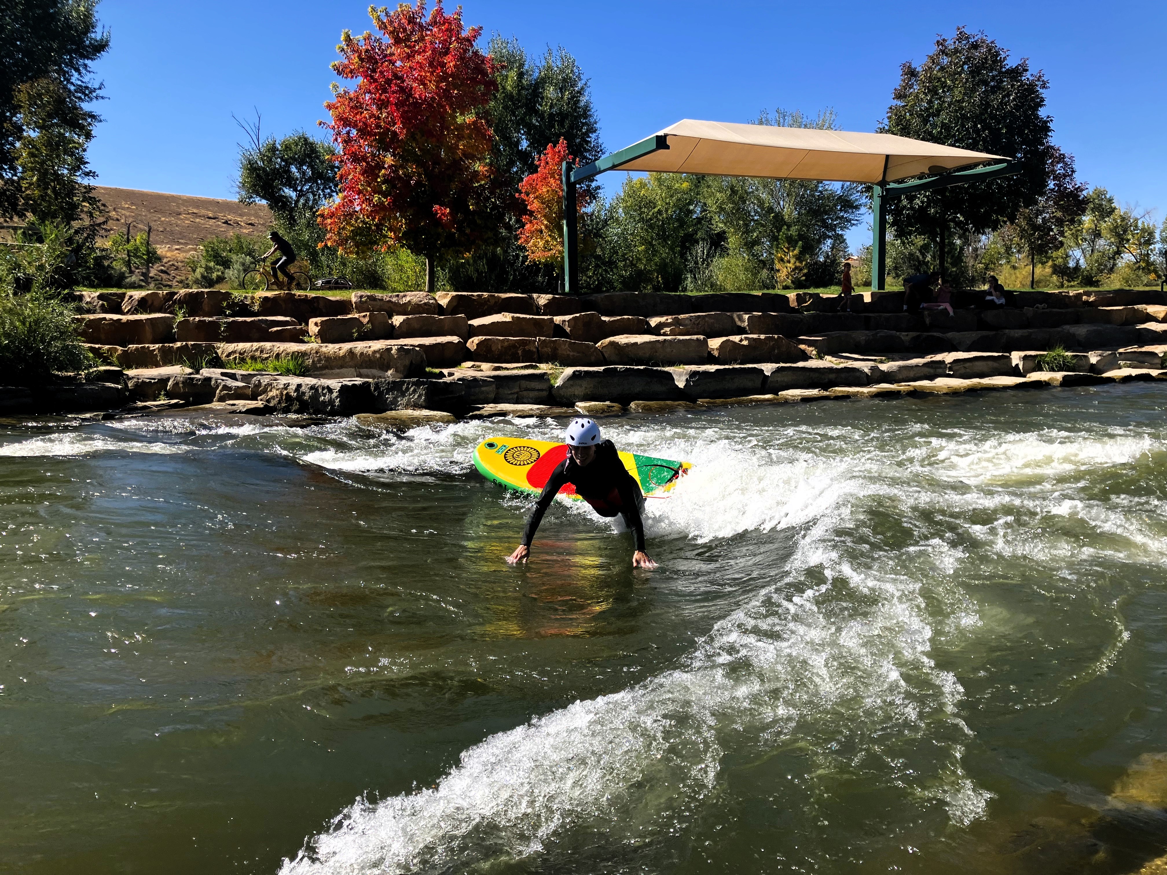 High School student river surfing at the Montrose Riverbottom Park