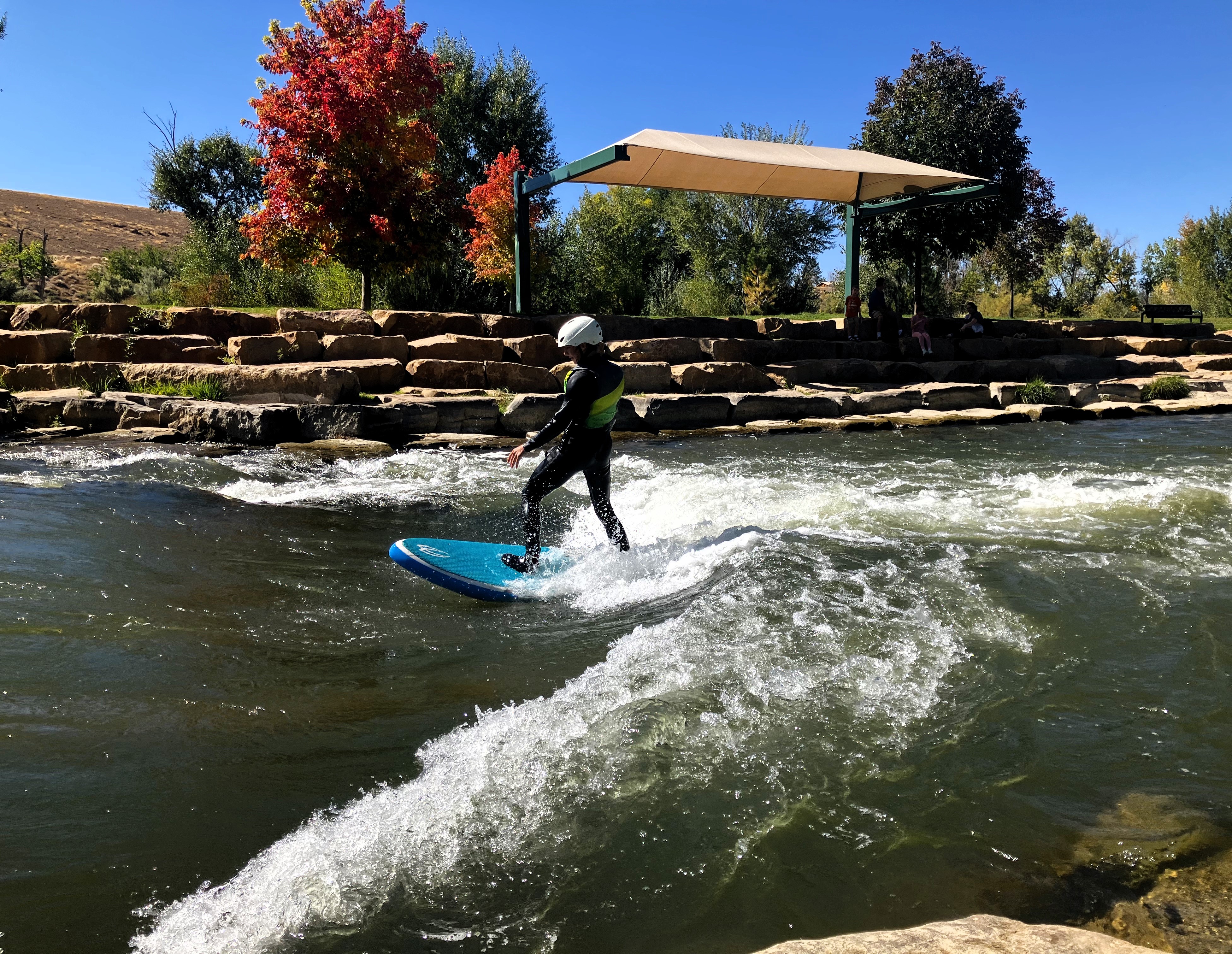 High School student river surfing at the Montrose Riverbottom Park