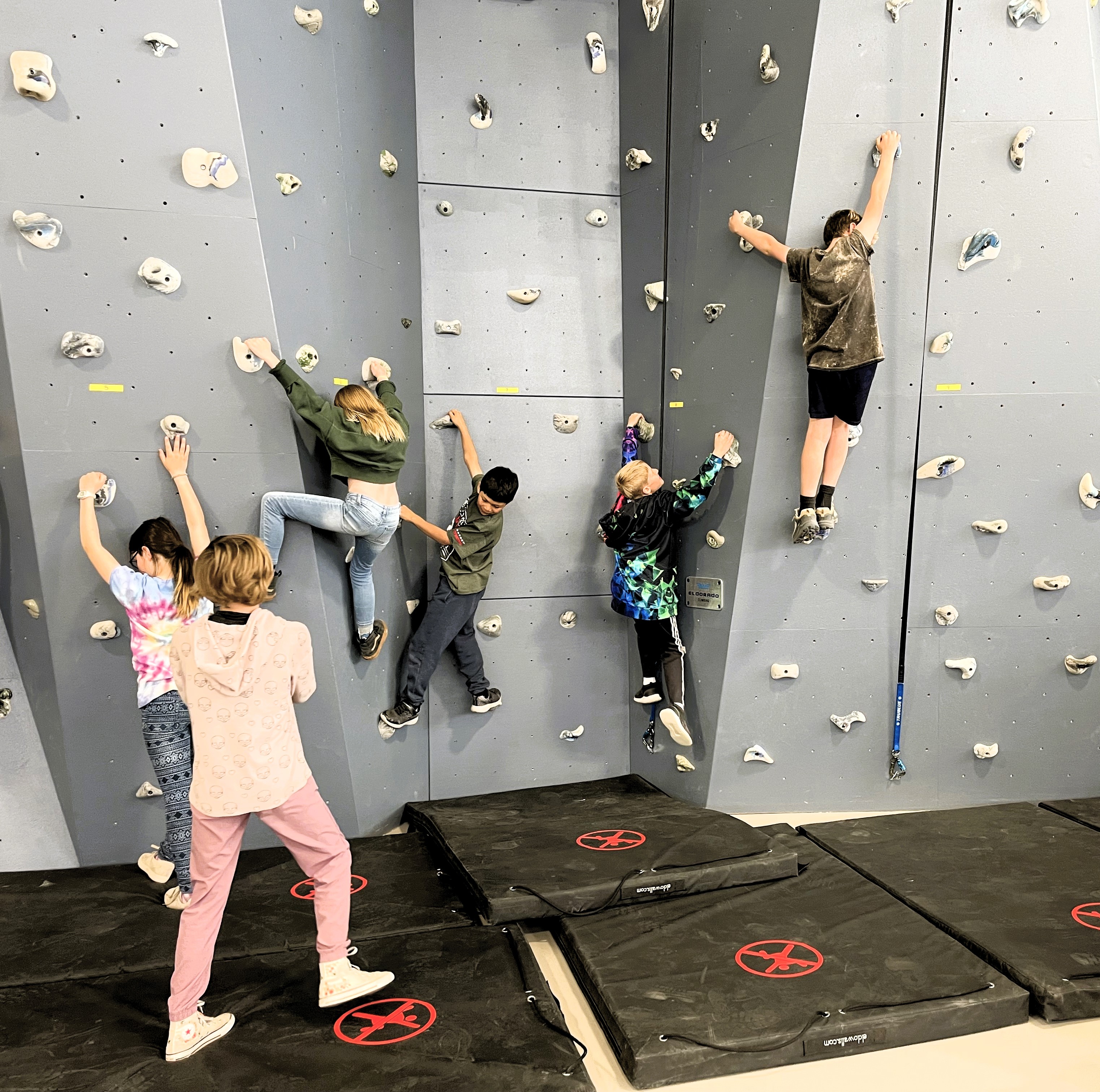 3rd graders bouldering a climbing wall