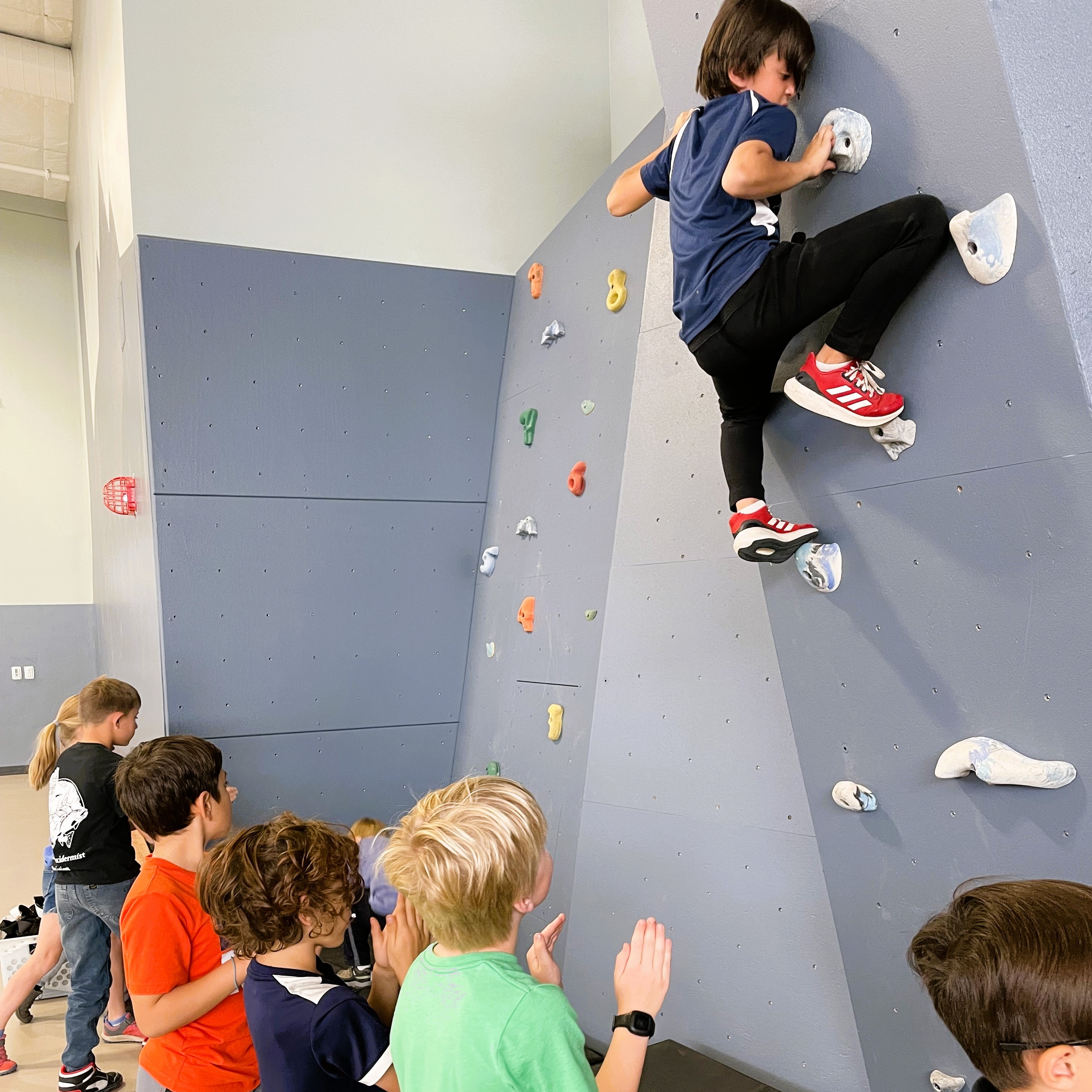 3rd graders bouldering the climbing wall