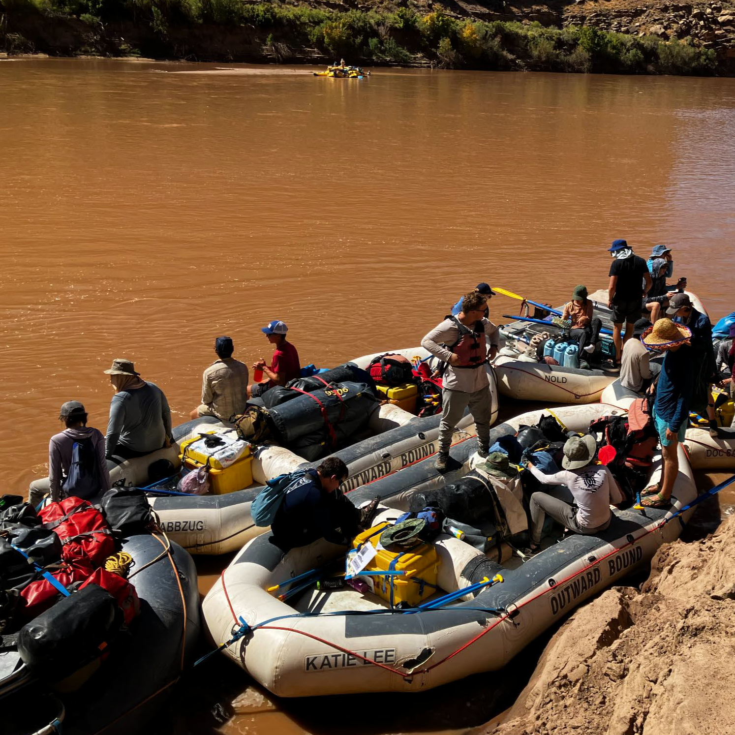 Seniors loading onto the rafts on the river