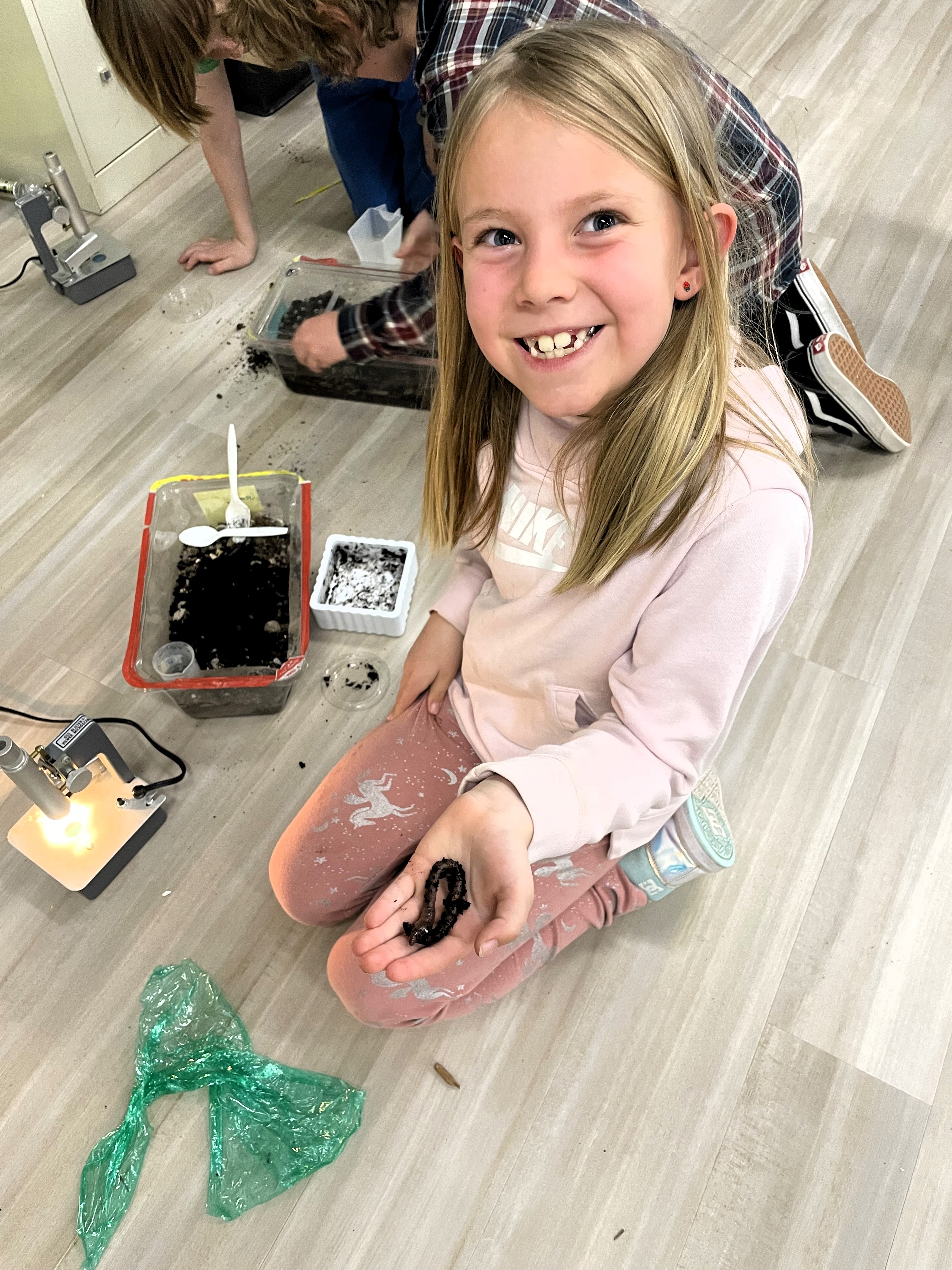 2nd grader holding worms