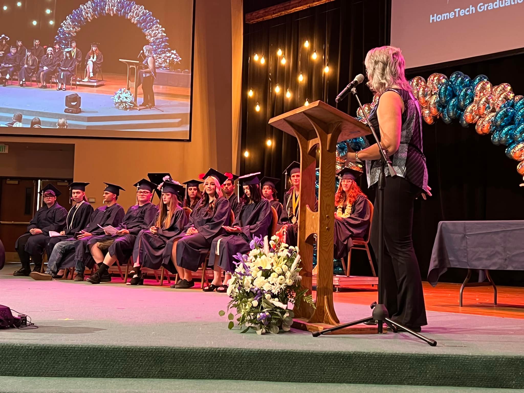 Pictures of 2022 graduation ceremony. Students on stage with decorations