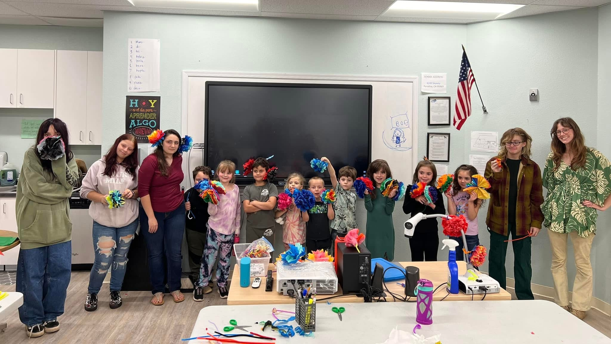 Spanish 2 Class making paper flowers with elementary students