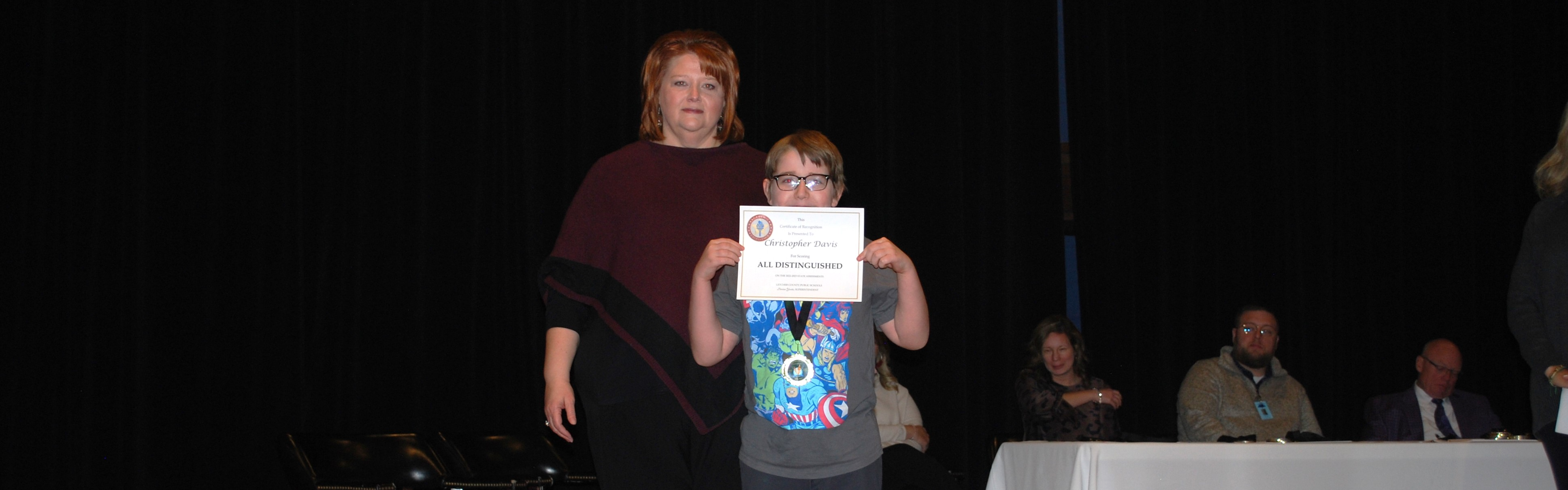 Arlie Boggs Elementary student receiving all distinguished test award.