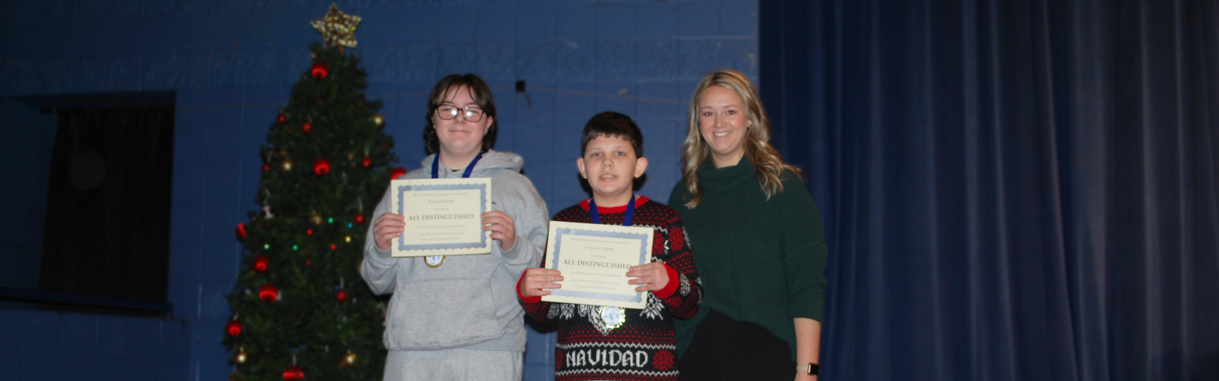 Letcher Elementary and Middle students receiving certificate for scoring all distinguished on 23-24 Kentucky Assessment.