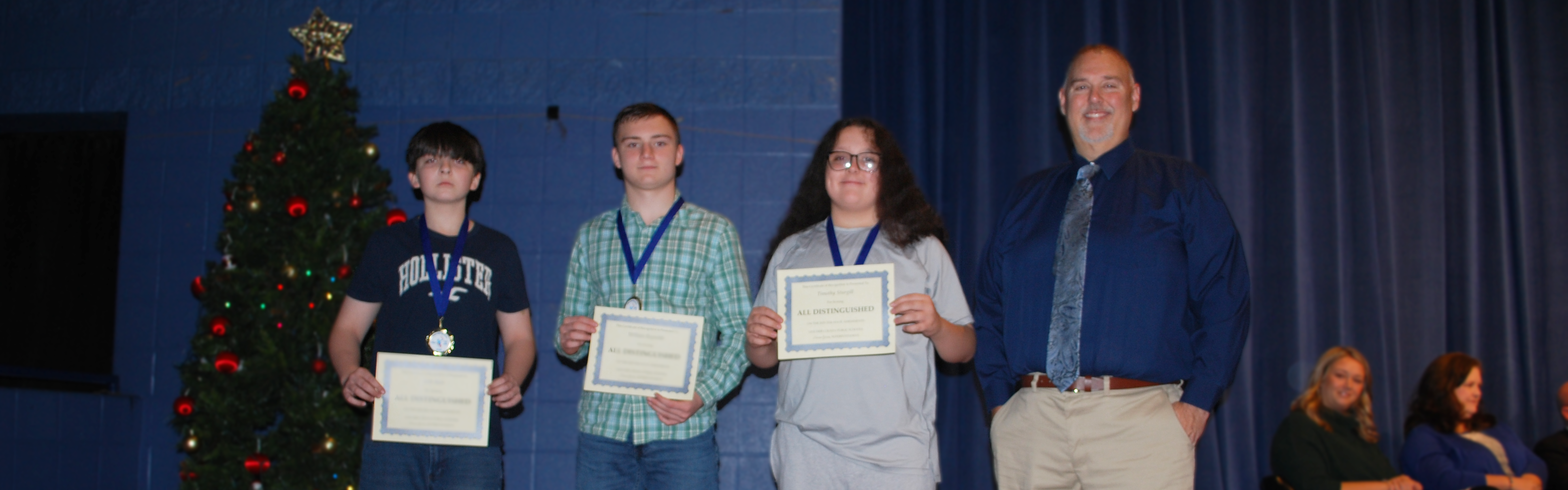 Whitesburg Middle students receiving certificate for scoring all distinguished on 23-24 Kentucky Assessment.