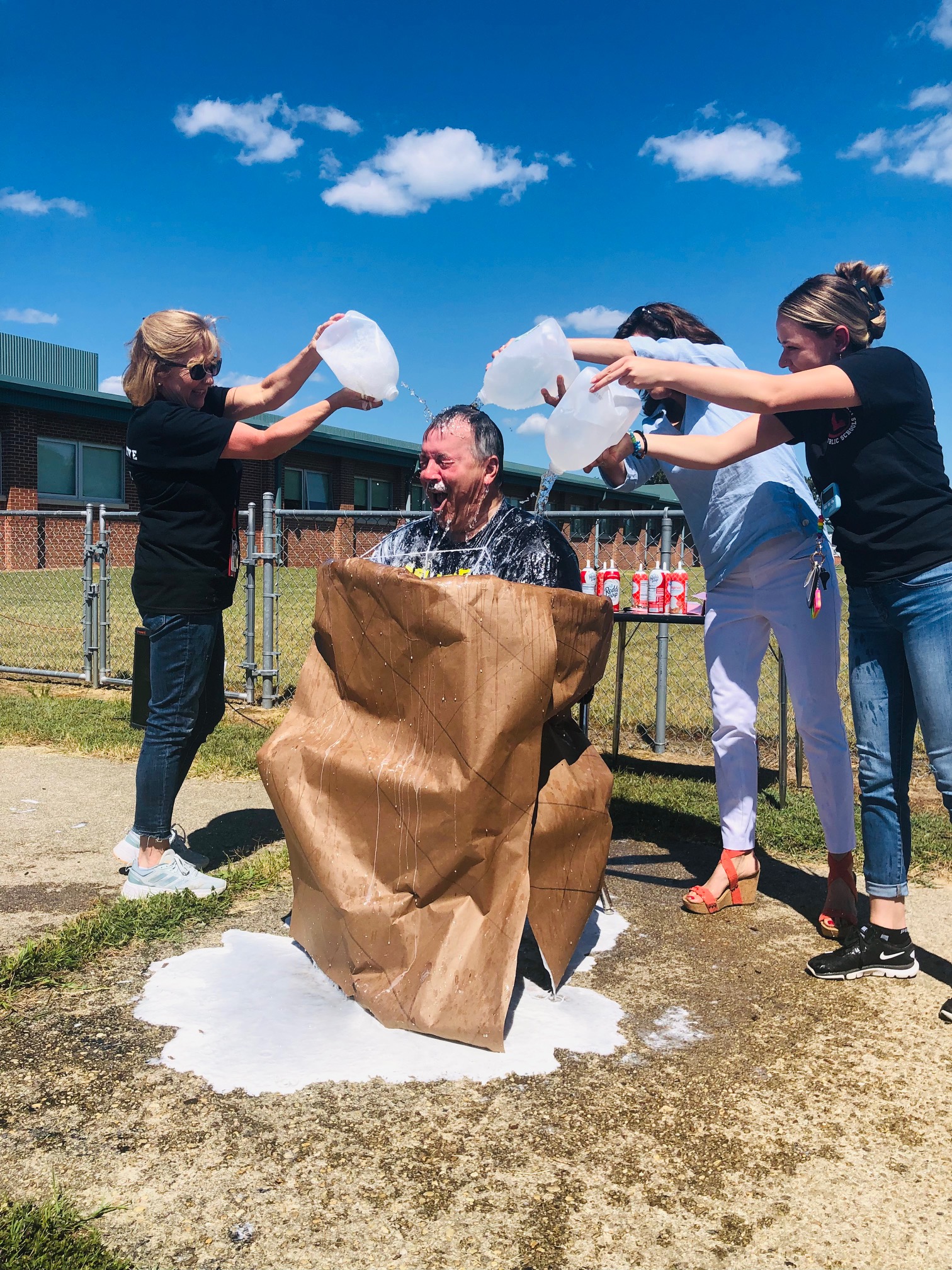 Teachers pouring water on Mr. Meyers.