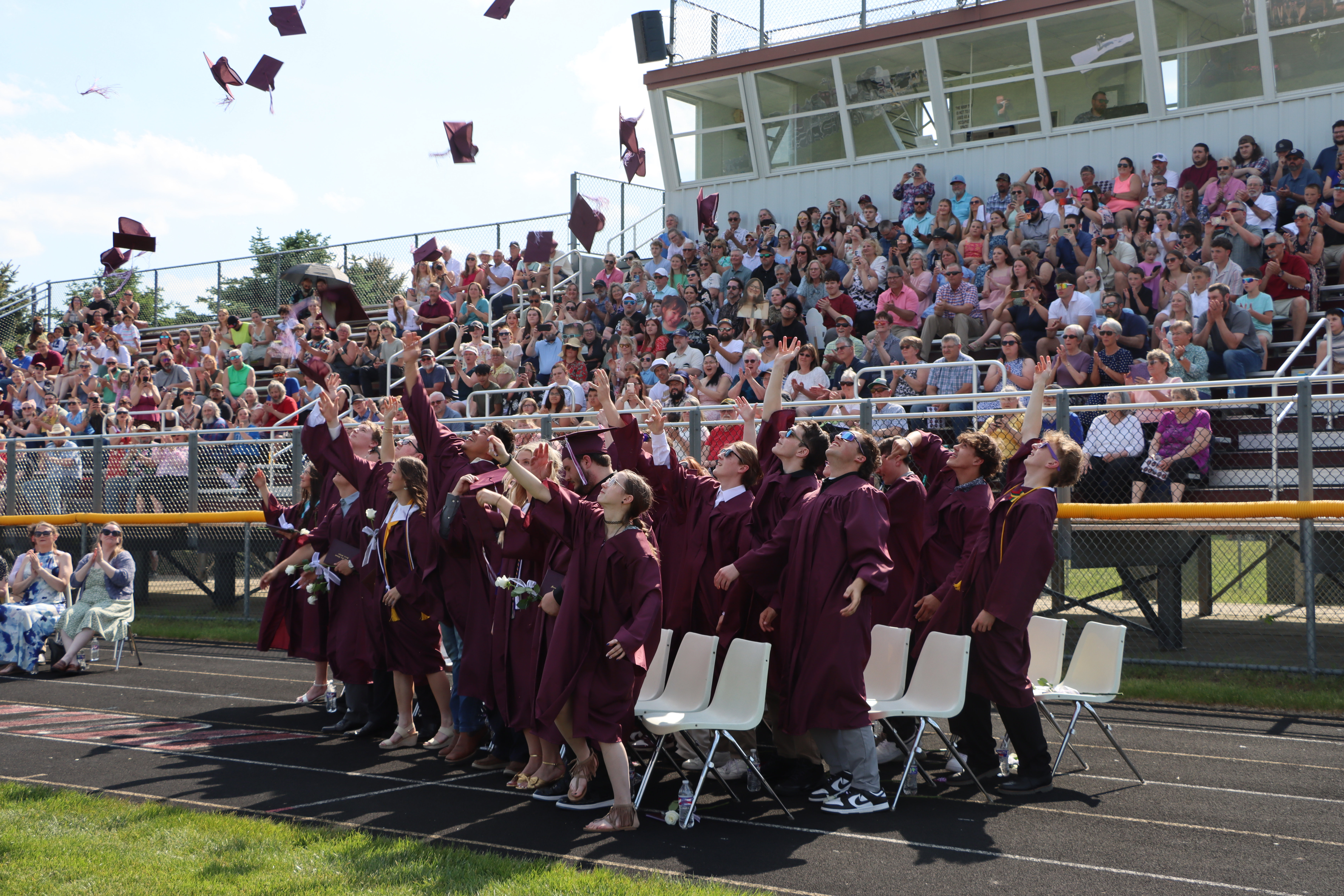 graduates throwing their caps
