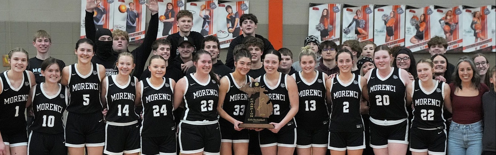 basketball players holding trophy