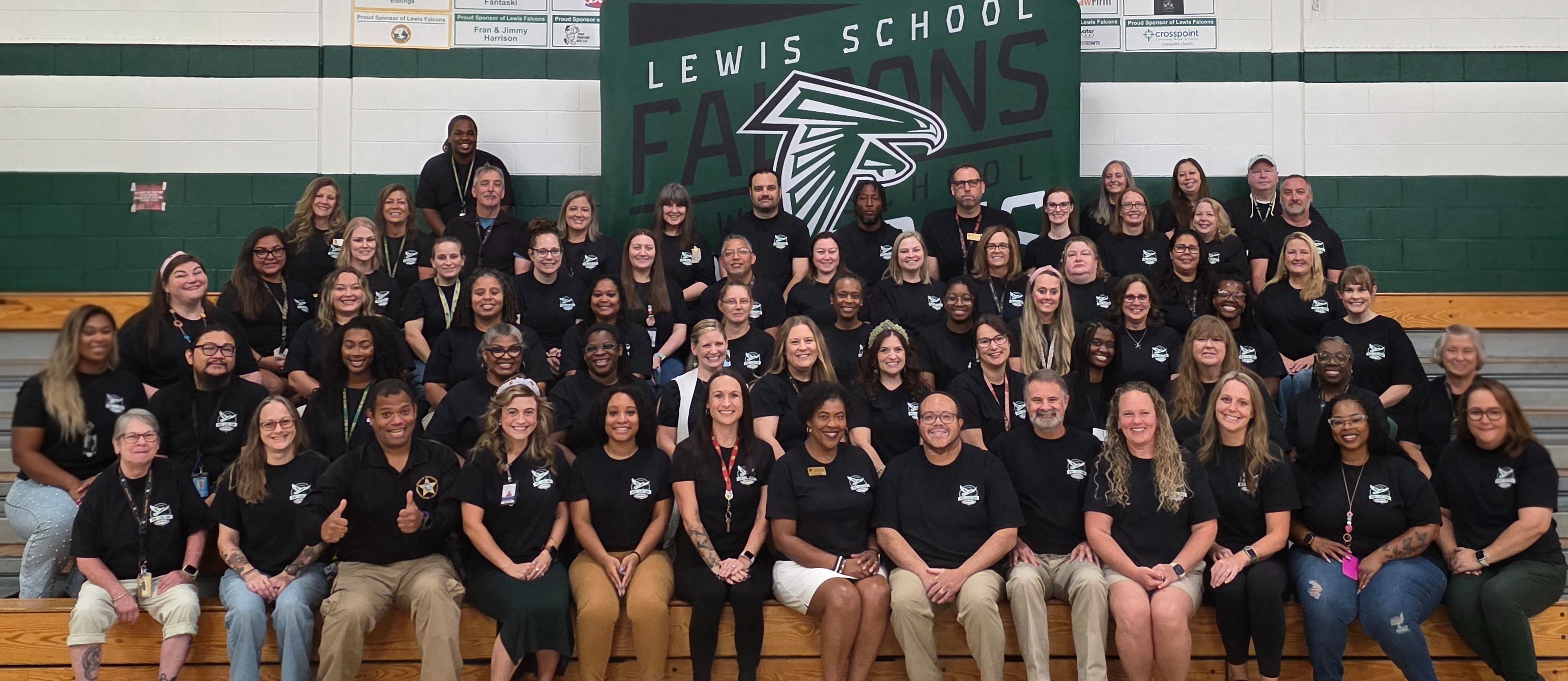 Lewis staff picture in the gym