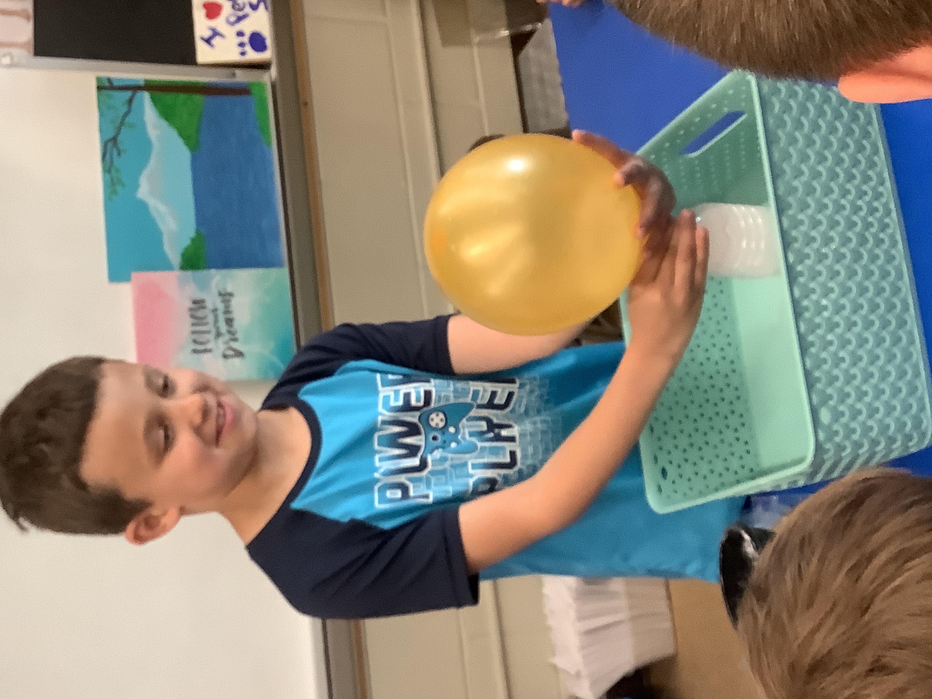 Boy filling balloon with gas