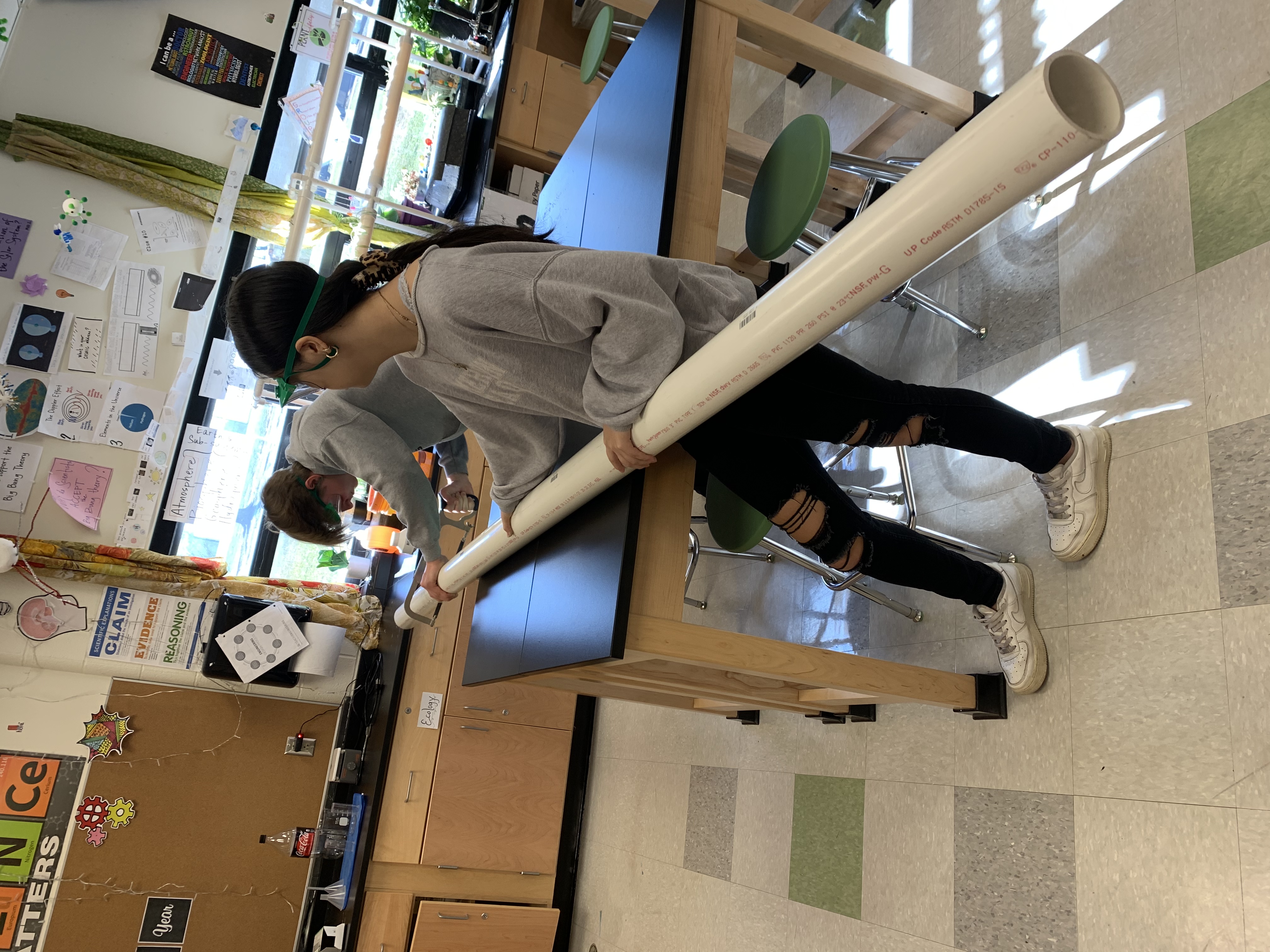 Kids cutting PVC pipe