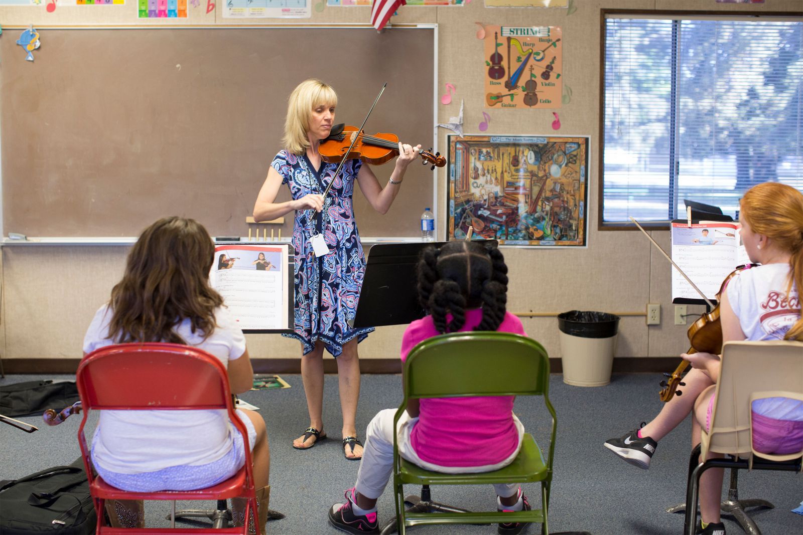 Mrs. Van teaching orchestra