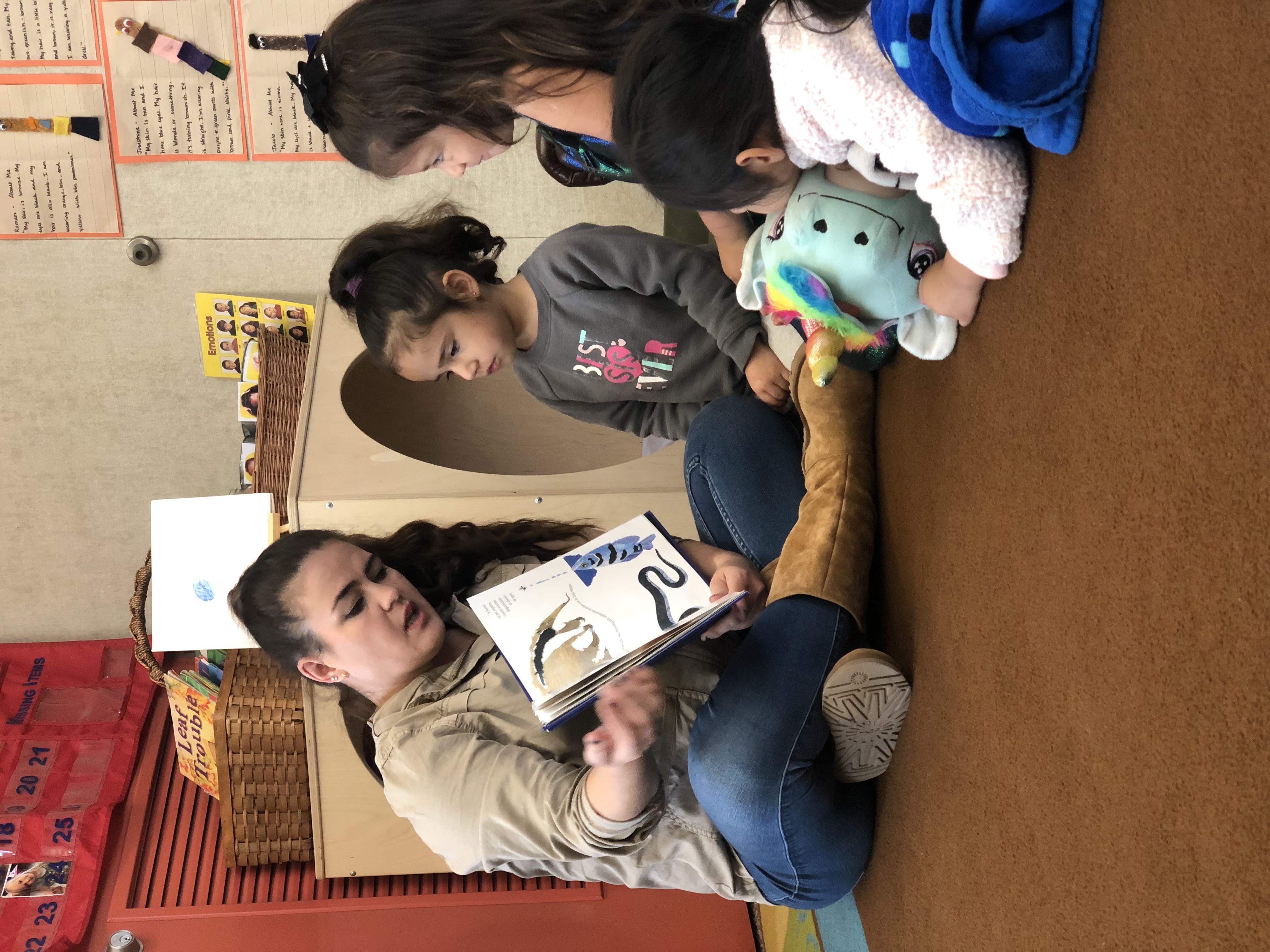 Teacher reading book to children
