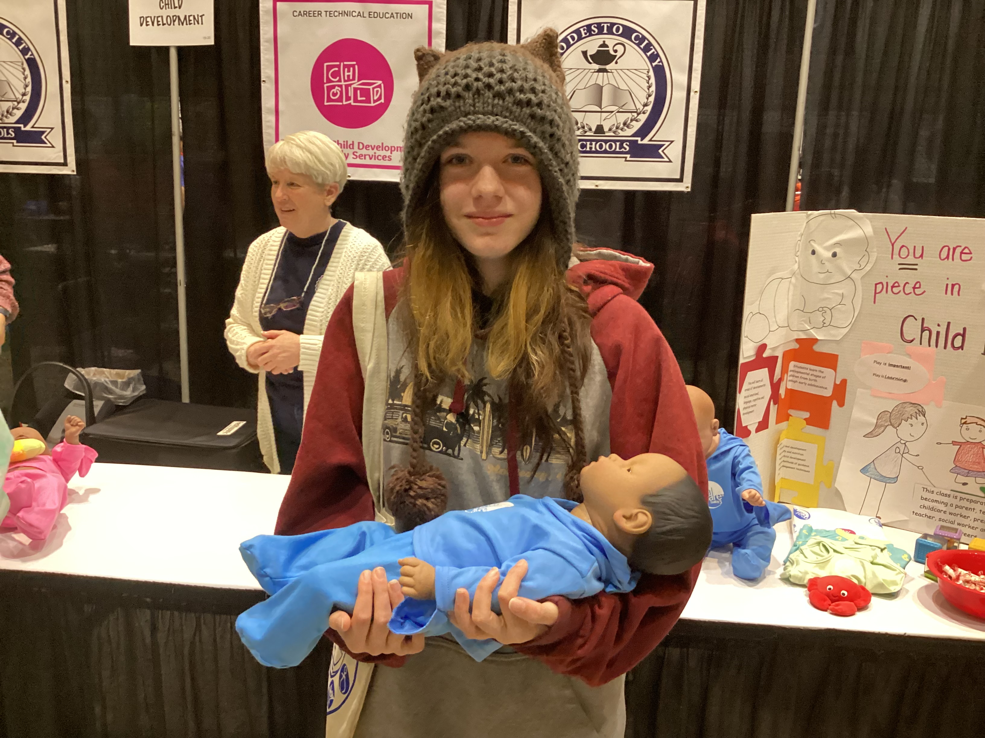 student-holding-baby-doll
