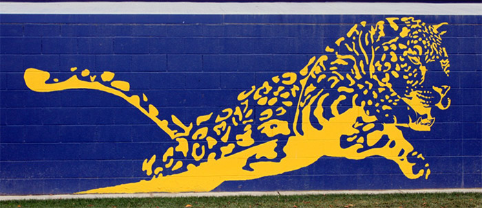 Jaguar painting on dark blue brick