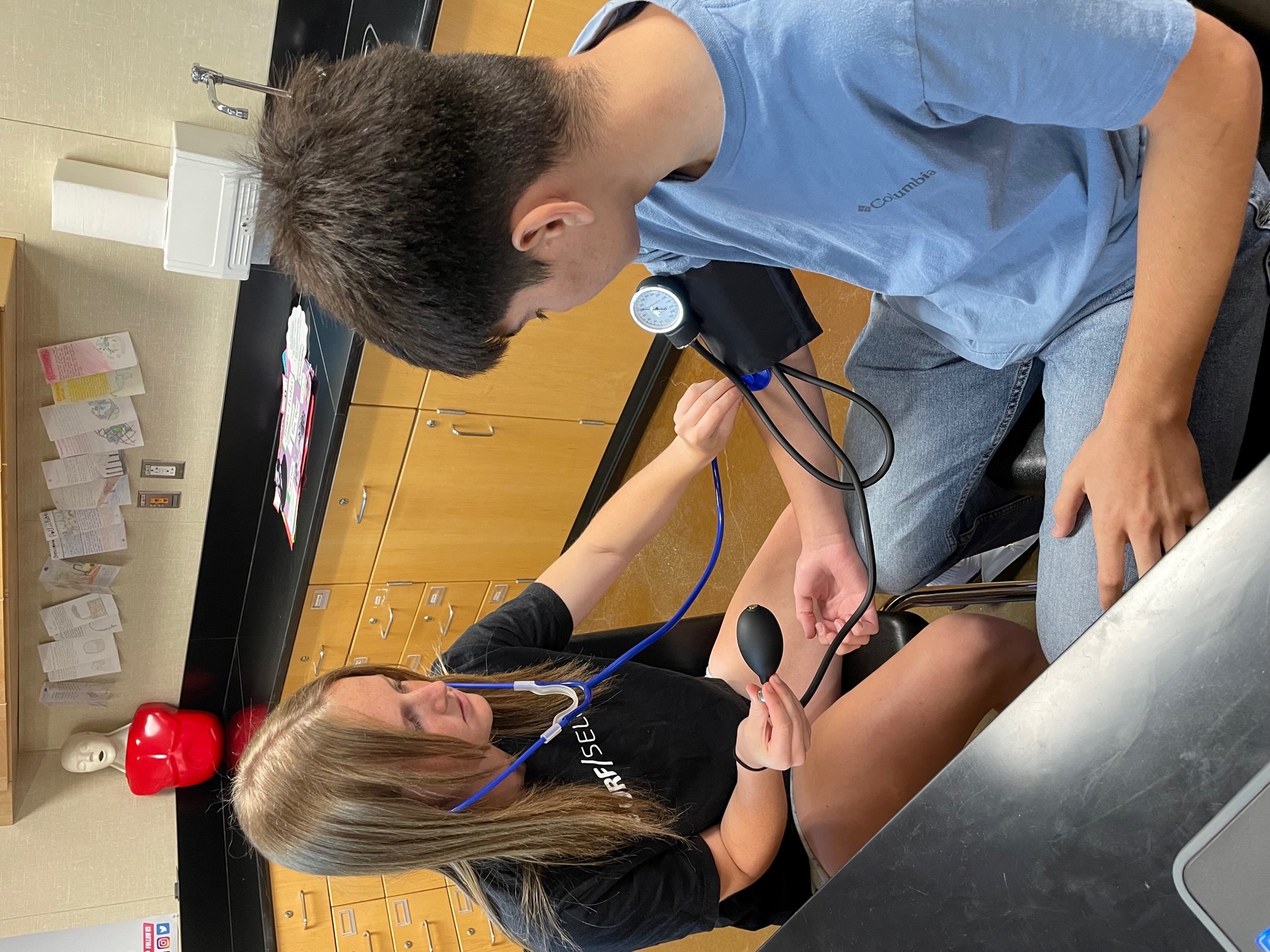 Student taking blood pressure