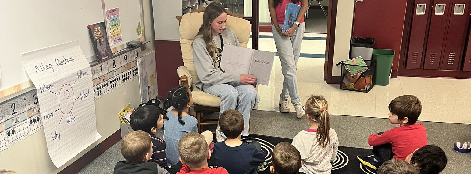 students reading to elementary students