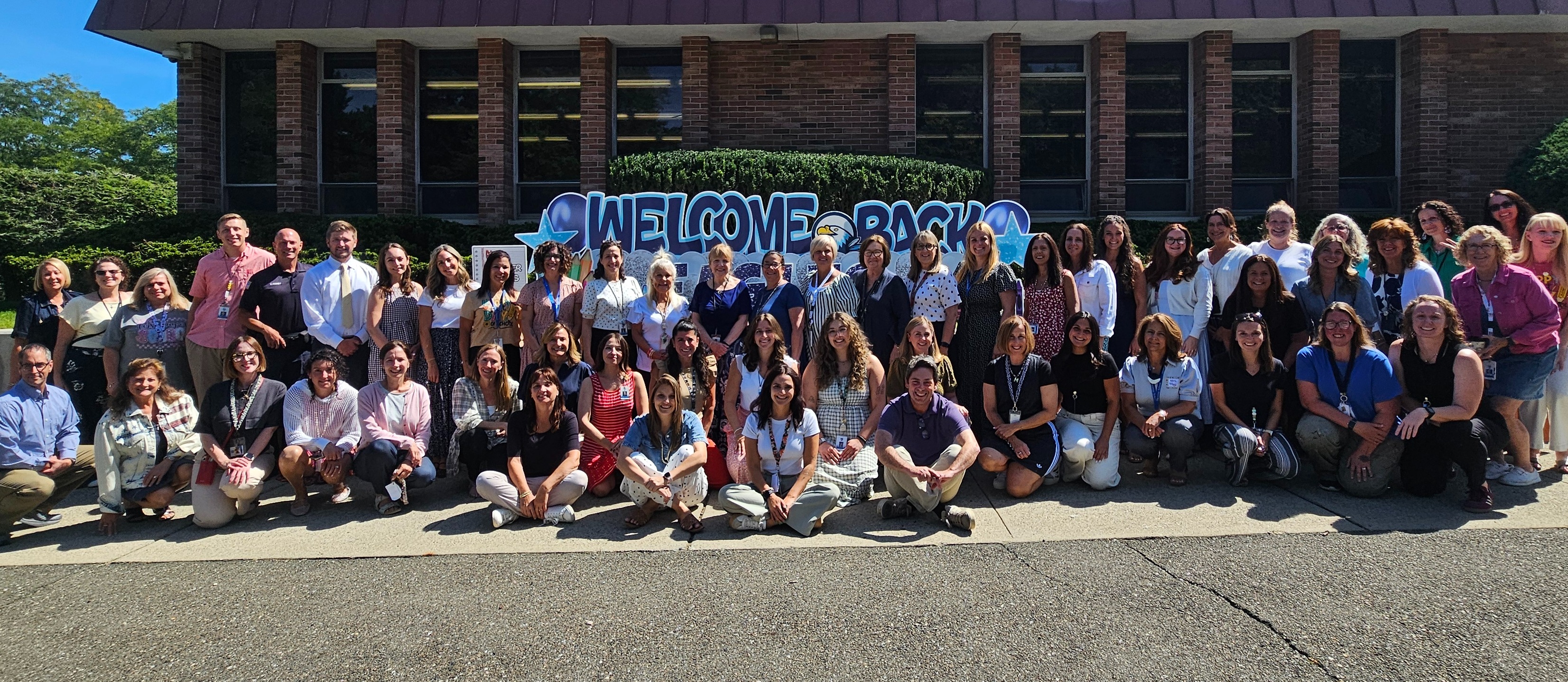 Sicomac Staff in front of the building