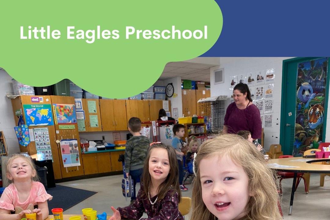 Preschool student holding up both hands with paint on  them